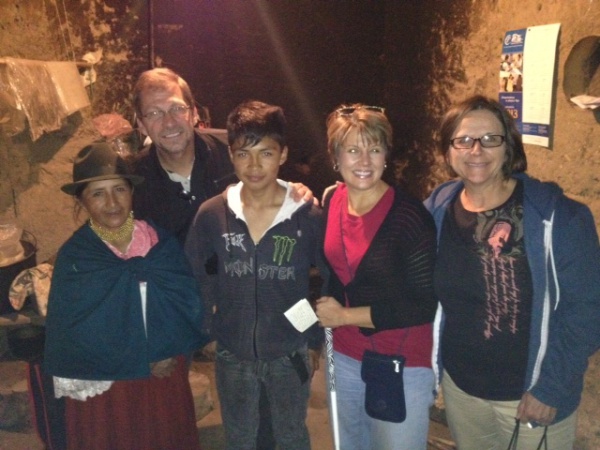 Theresa, Phil and Jennifer with Bolivia and 14-year-old Jimmy in the kitchen of their adobe home. Jimmy is one of the children sponsored through Compassion.